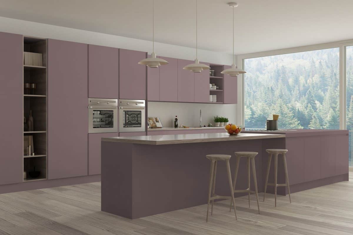 Lavender colored kitchen cabinet and cupboard panels and wooden countertop on the breakfast bar