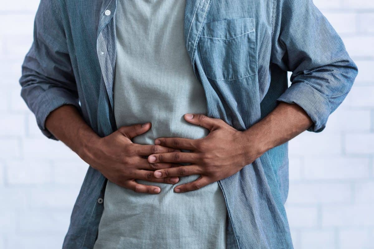 Man having a bad stomach ache due to food poisoning