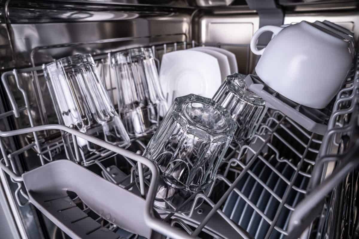 Mugs and plates inside a dishwasher