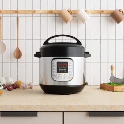 Multi Cooker On Kitchen Counter With Onions, Garlic, Cooking Oil And Cutting Board - Why Does My Rice Cooker Bubble? And How To Prevent This
