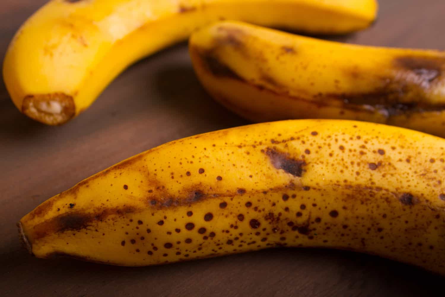 Ripe organic bananas on wooden background