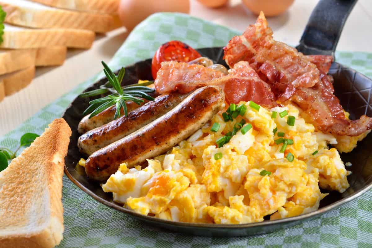 Scrambled eggs with bacon, parsley, and sausage