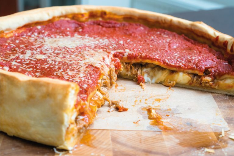 Top view of Chicago pizza. Chicago style deep dish italian cheese pizza with tomato sauce and beef. How Deep Is A Chicago Deep-Dish Pizza 