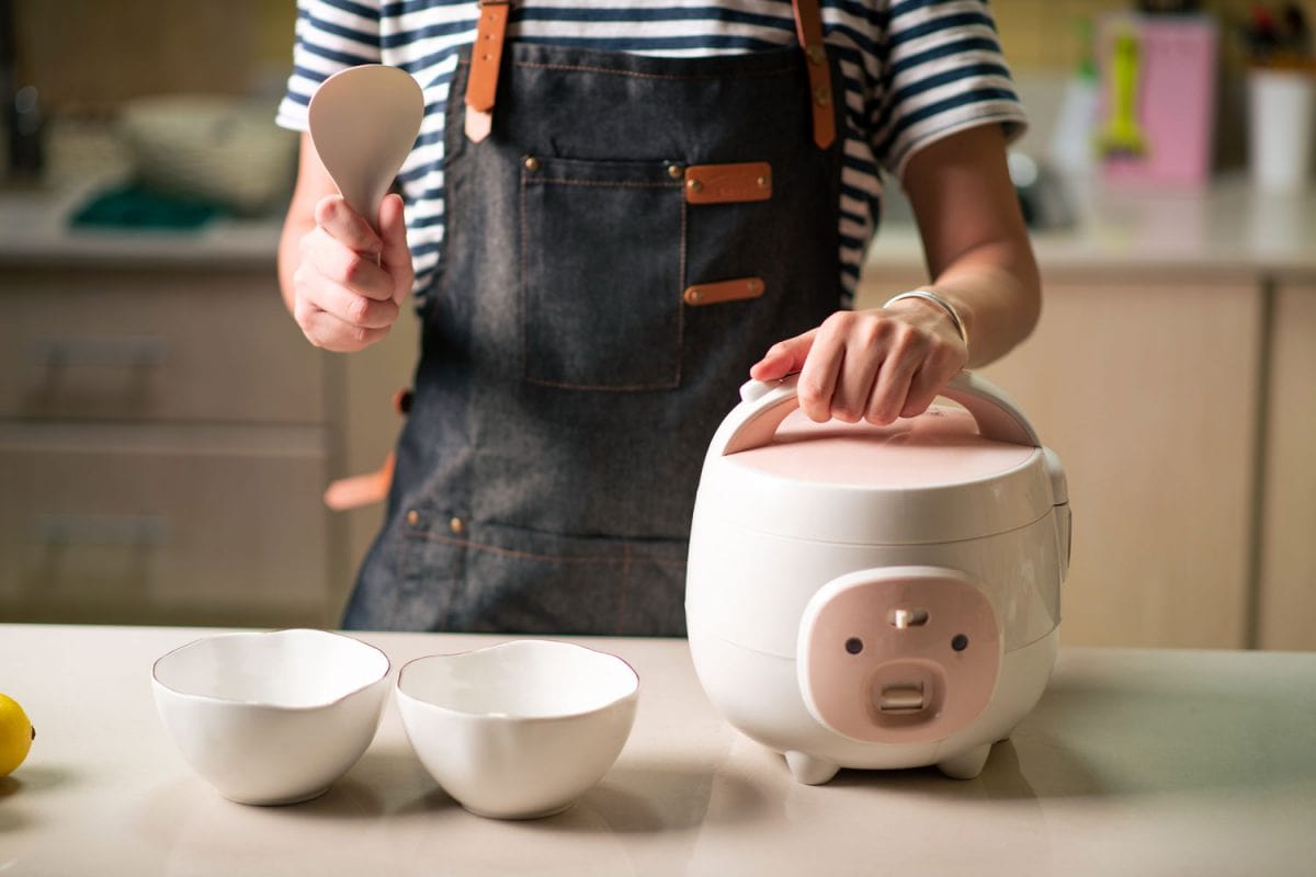 Woman holding her rice cooker