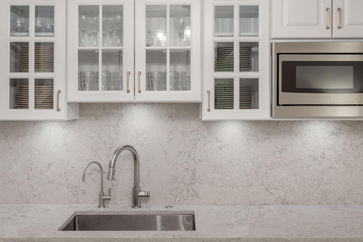 Soap stone countertop and backsplash with gold color handles