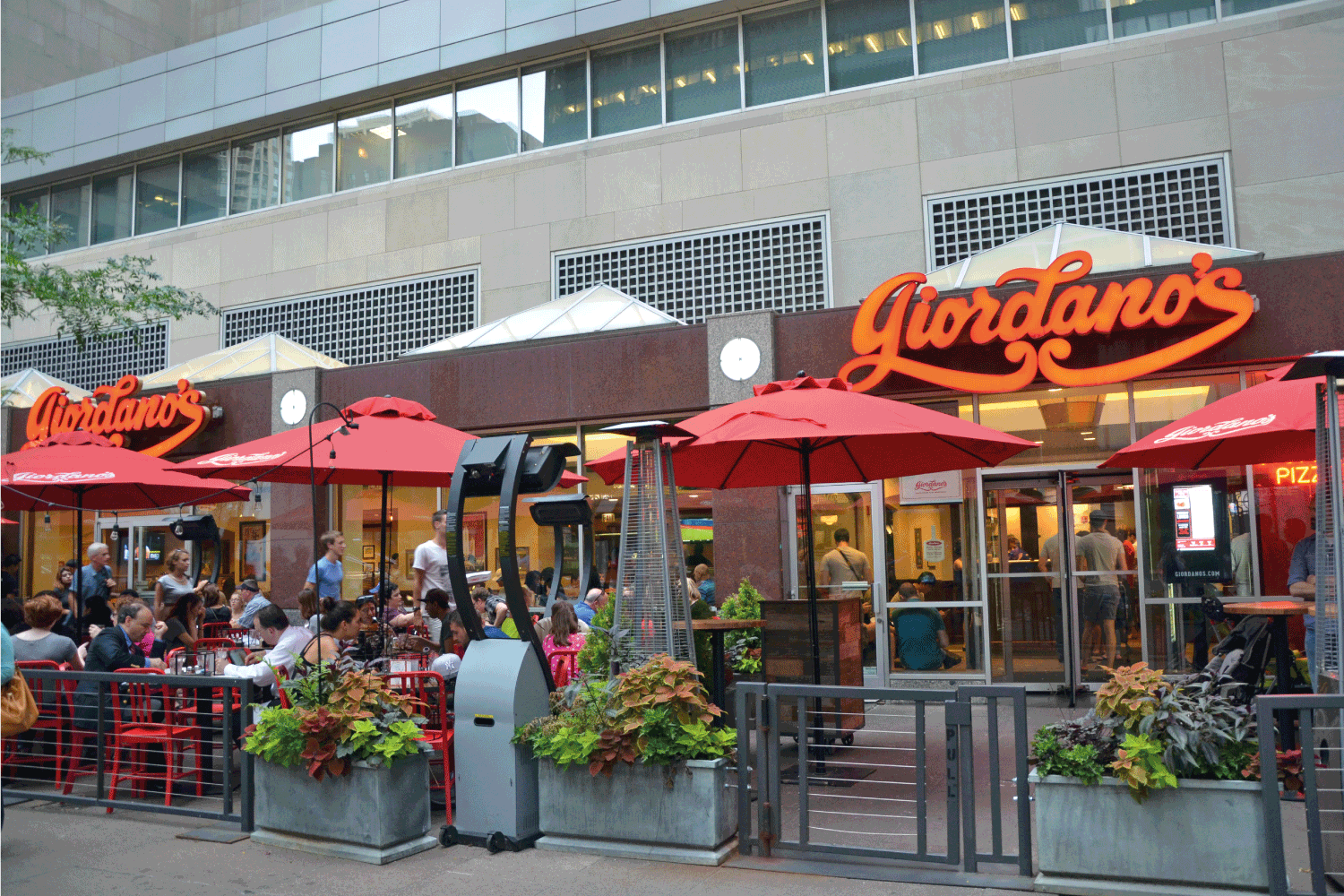 people at Giordano's restaurant in the Loop District, Chicago, USA. The restaurant is famous for the Chicago style deep dish pizza
