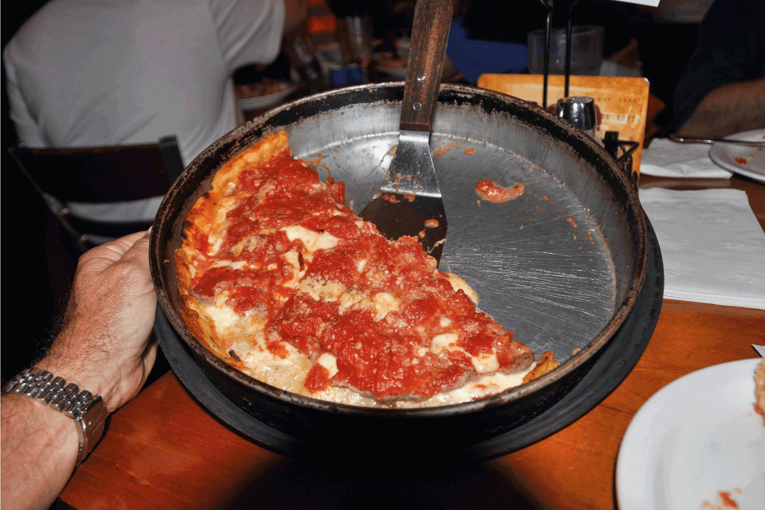 photo of a Chicago-Style Deep Dish Pizza on a dinner table