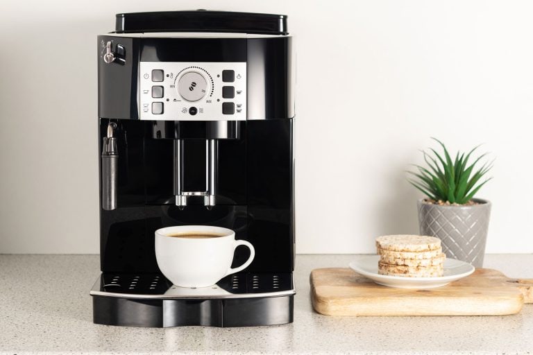 A coffee maker pouring coffee into a cup, Bold Setting On Coffee Maker: What Does That Do?