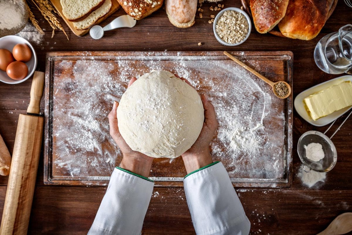 Artisan chef hands kneading dough