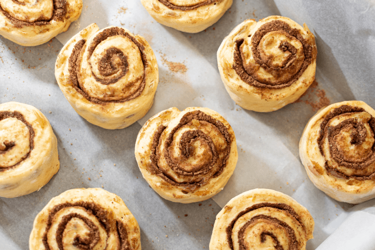 Cinnamon rolls on a parchment paper, At What Temperature To Bake Cinnamon Rolls?