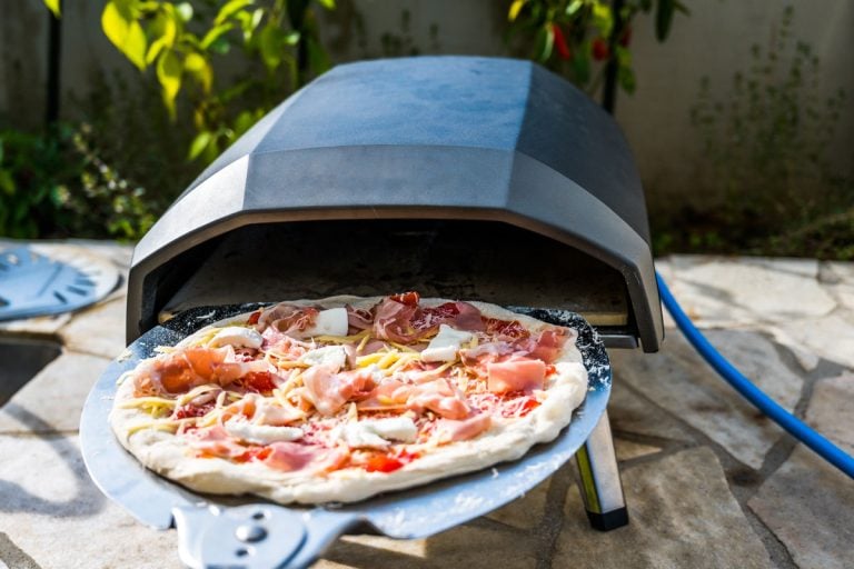 Delicious pizza is baking in gas oven furnace for home made Neapolitan pizza, Can Ooni Pizza Oven Be Used Indoors?