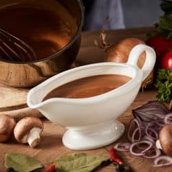 A delicious spicy rich gravy whisking it in a pot with spicies, Gravy Too Thick? Here's How To Thin It Out!