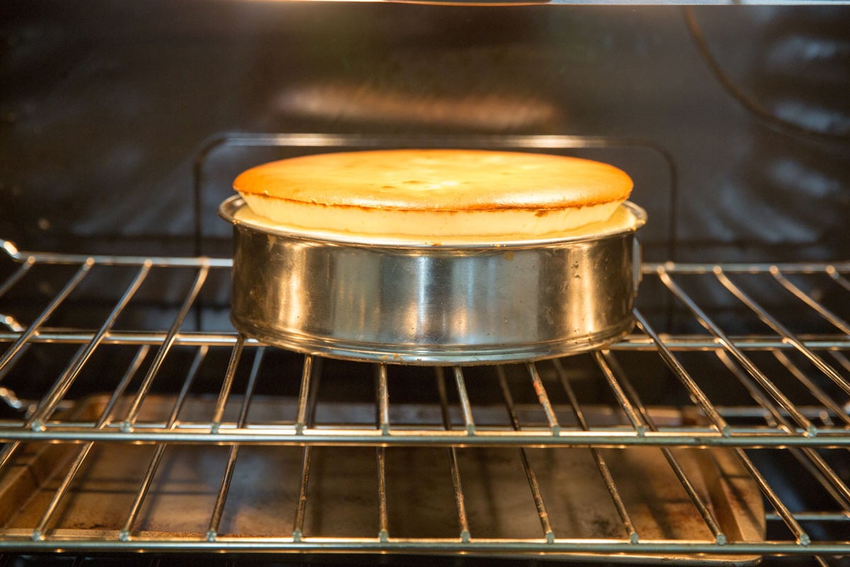 Homemade cheesecake rising in the oven
