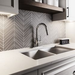 Interior of a modern kitchen with a grey patterned backsplash, pull down faucet in a double sink with white countertop, What Color Kitchen Cabinets Go With Gray Walls?
