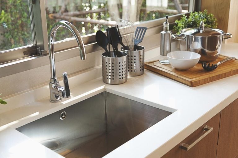 A kitchen sink and faucet on the kitchen, How Far Should A Kitchen Sink Be From Edge Of Counter And From Wall?