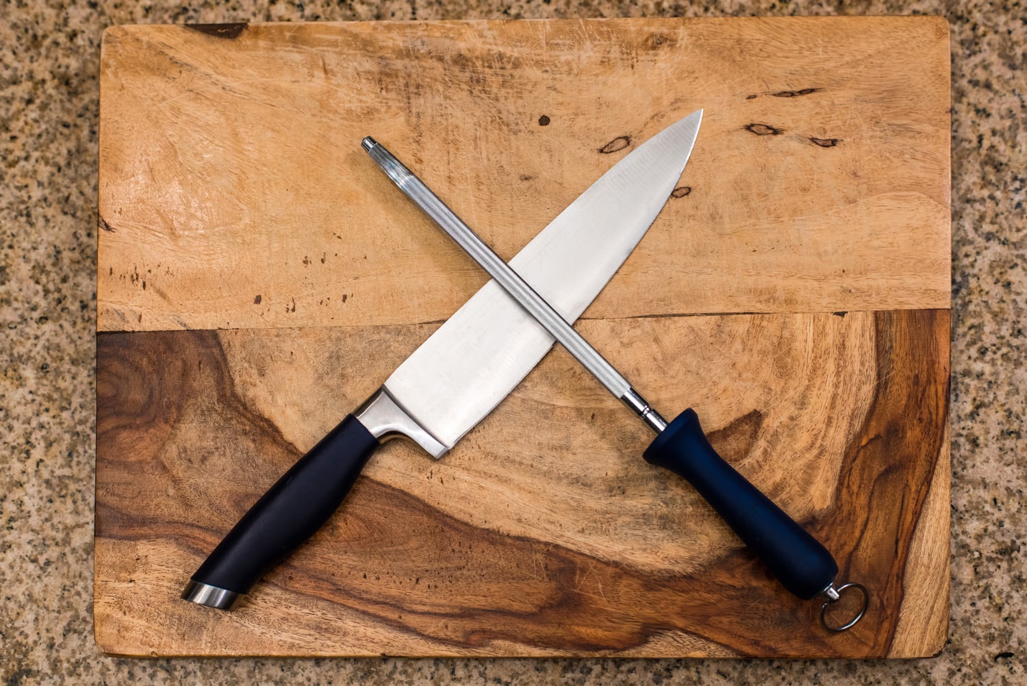 Knife & Sharpener On A Cutting Board