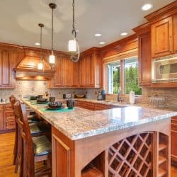 Oak cabinets and cupboards inside a rustic kitchen with hardwood flooring, What Color Countertops Go With Maple Cabinets?