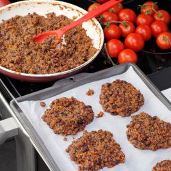 Parchment paper lined cookie sheet with quinoa and three bean patties ready to be cooked, Can You Use A Baking Sheet As A Griddle?
