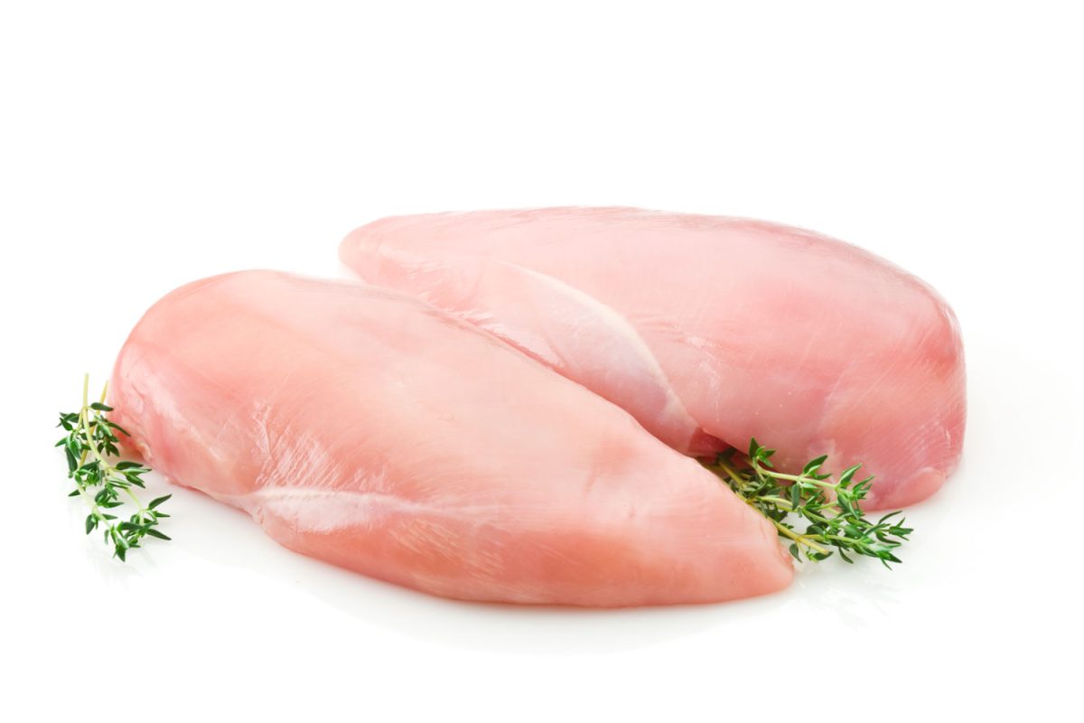 Raw chicken breasts garnished with oregano
