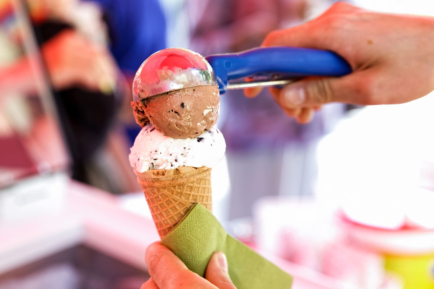 Serving ice cream scoops in a cone.