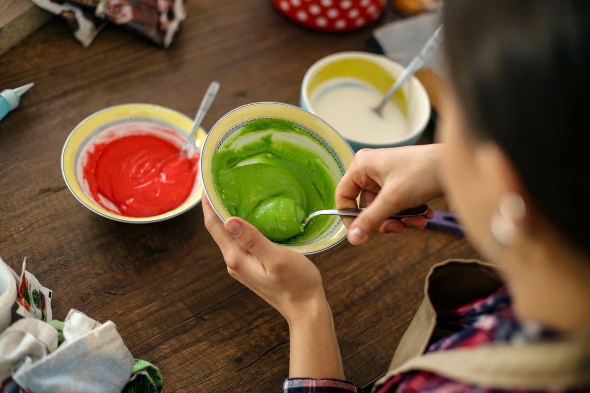 Woman mixing green food coloring