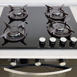 Modern built-in oven and gas stove classic design in dark tones under light stone marble or granite countertop, in interior of contemporary kitchen - How To Tell If My Oven Is Gas or Electric