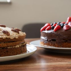 two delicious whole vegan cakes on a plate waiting on a dining table, Can You Bake Two Cakes At The Same TIme? - Inc. Pies and Cheesecake