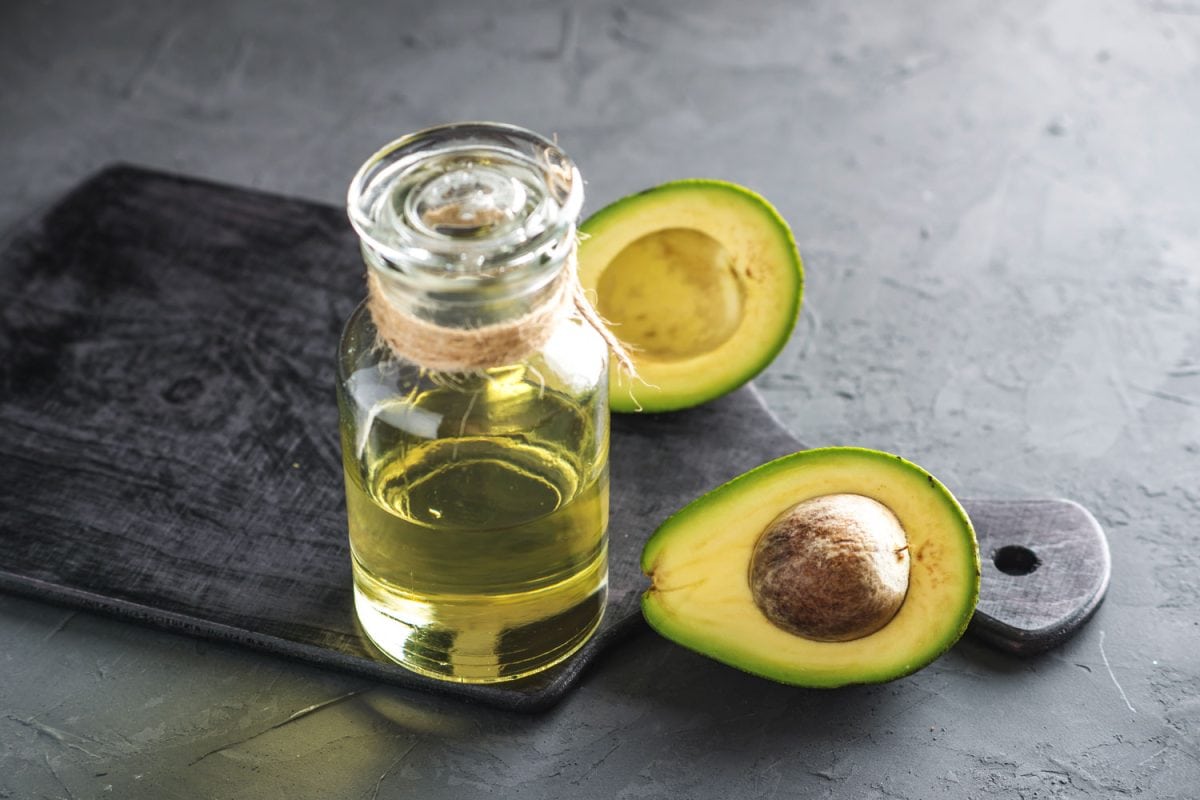 Avocado oil extract and a sliced avocado on the back
