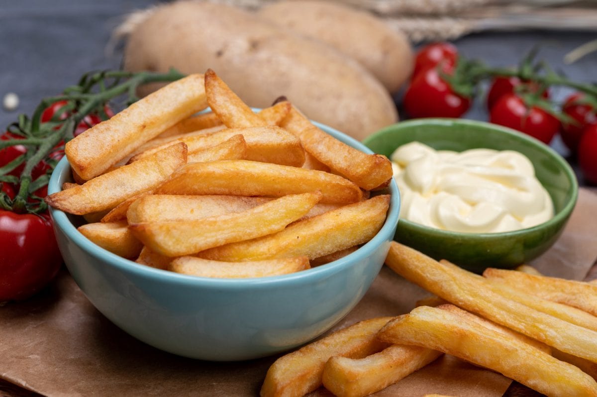 Bown with fresh cooked french fries potato chips with belgian mayonnaise sauce close up - How Much French Fries Per Person? [And How To Make Them Healthier]
