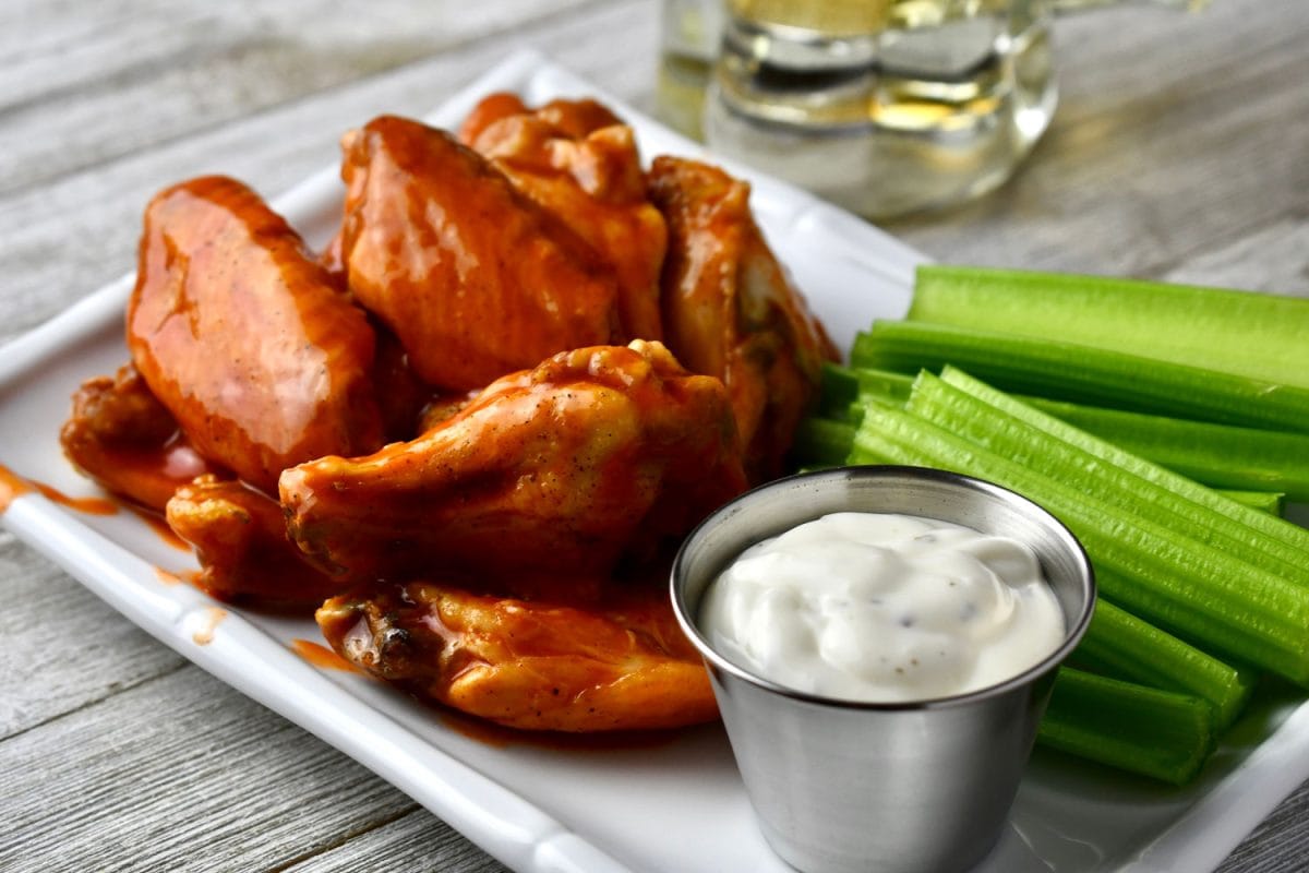 Chicken wings with celery and a ranch dip on the side
