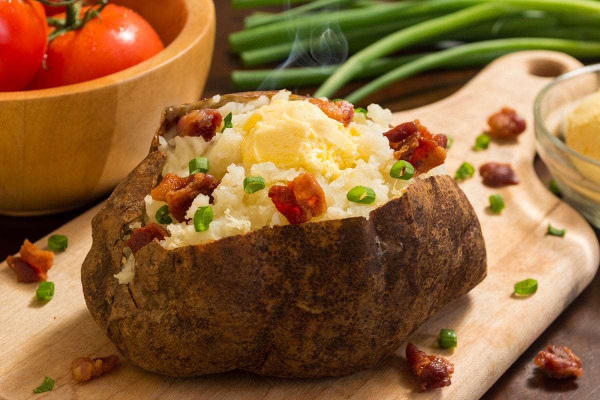 Freshly baked mashed potato with butter, bacon and cheese