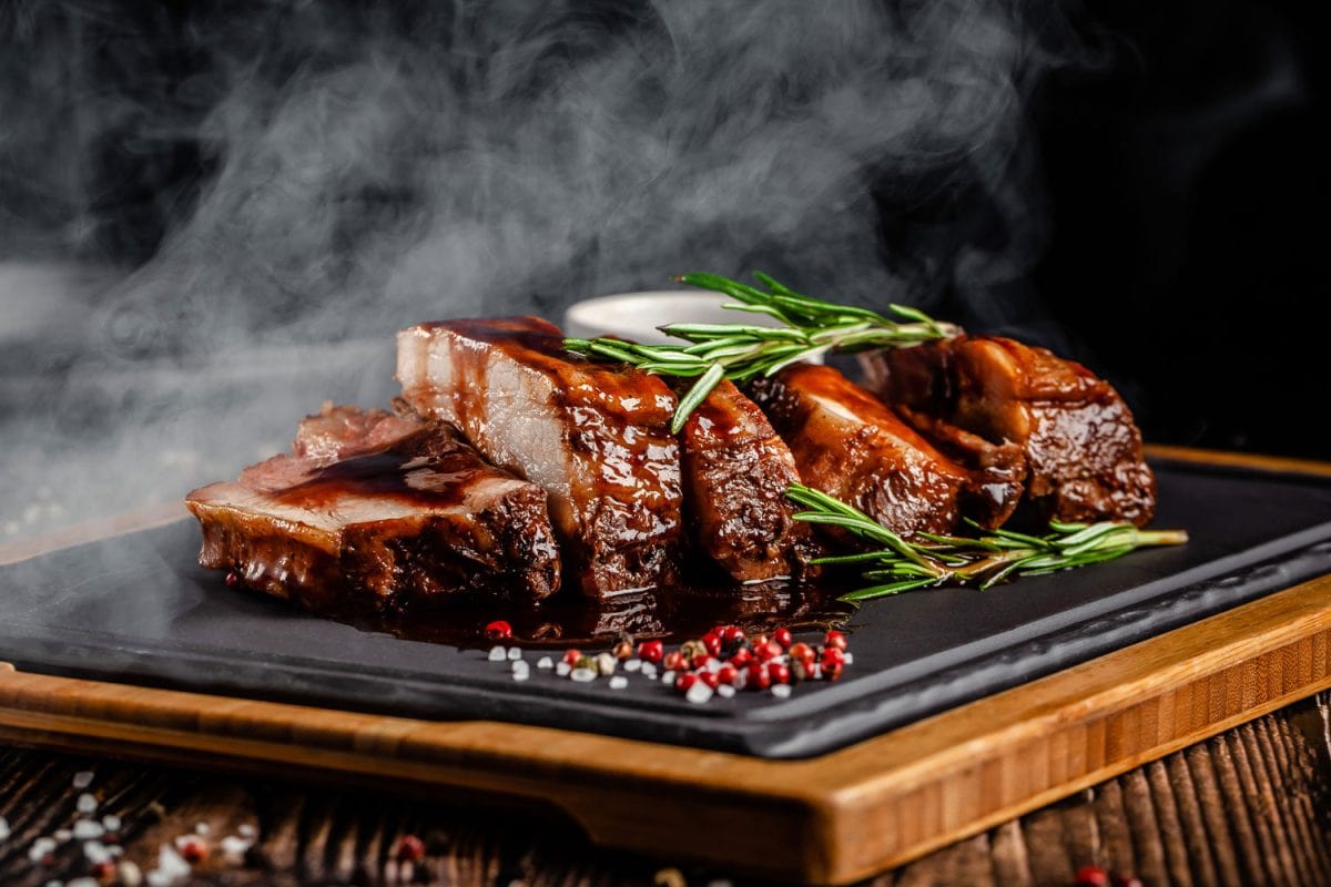 Freshly cooked ribs garnished with oregano, sesame seeds and rock salt