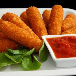 A fried mozzarella sticks with sauce dip and green leaves, How Long Do Cheese Sticks Last?