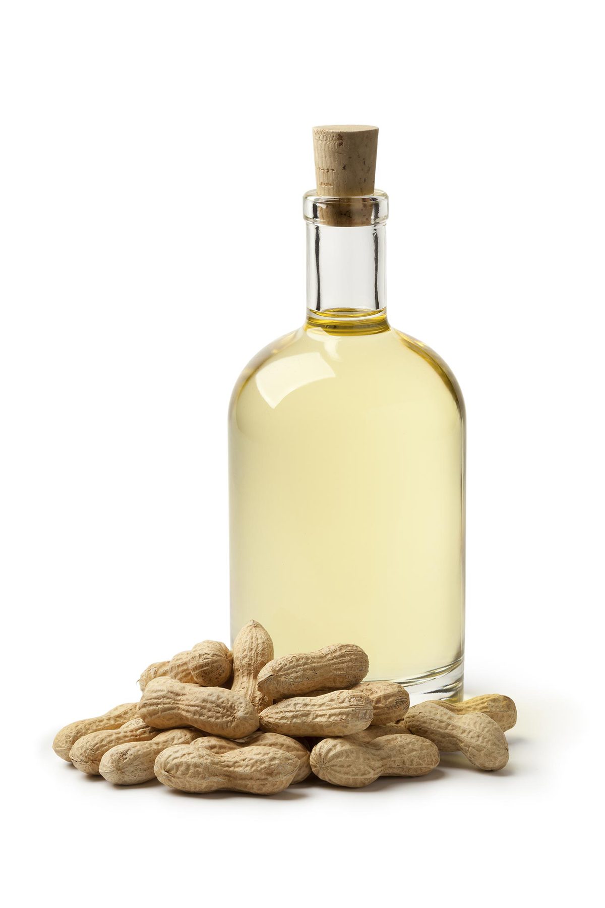 Glass bottle of peanut oil and peanuts