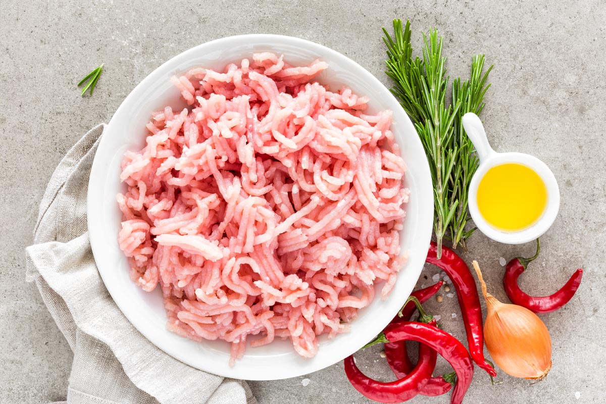 A ground meat with ingredients for cooking, Can You Mix Ground Turkey And Ground Beef?