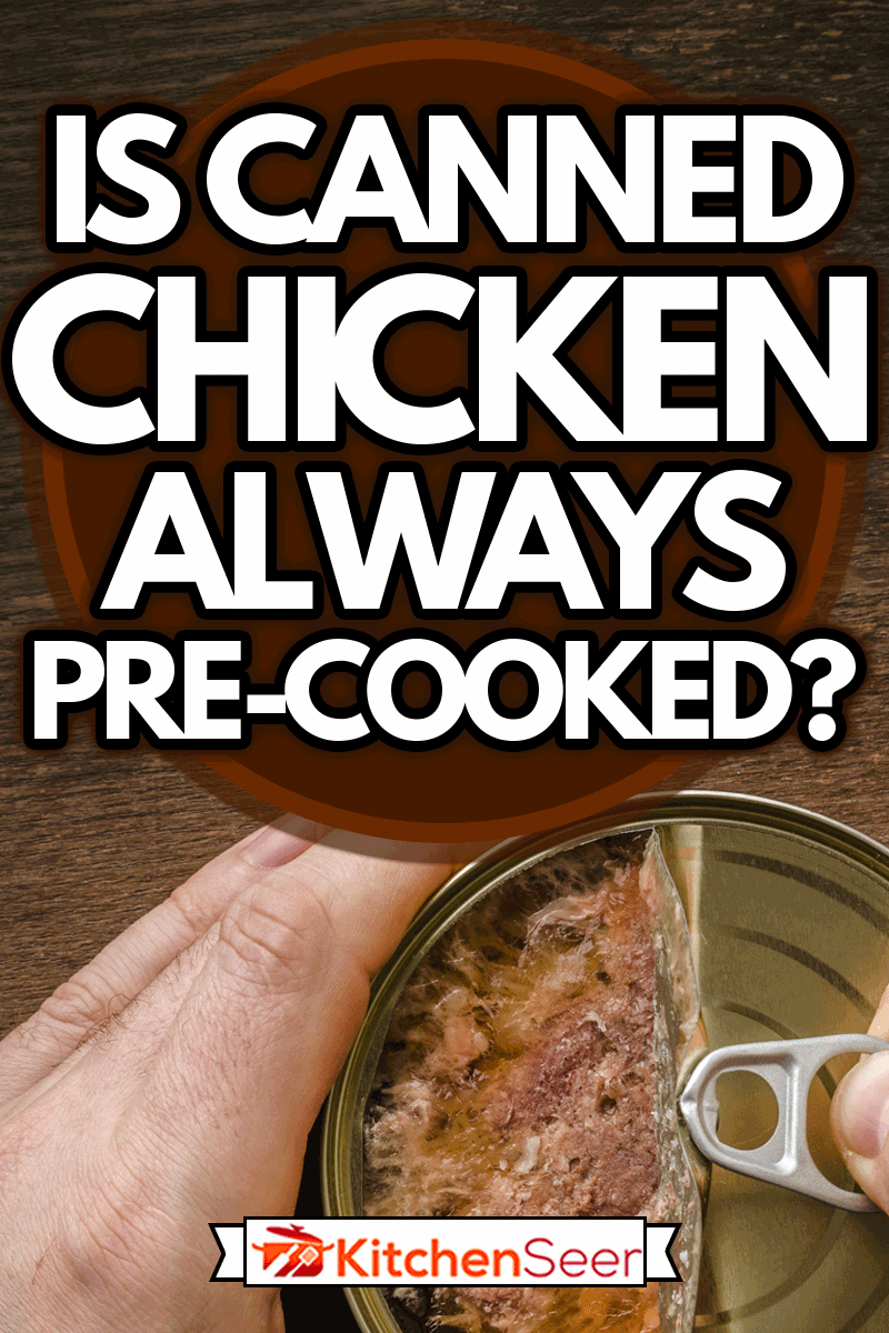 Man hands opening tin can with chicken meat on dark wooden table background, Is Canned Chicken Always Pre-Cooked?