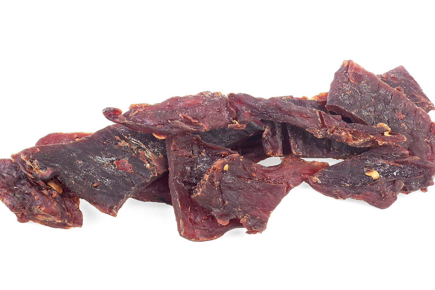Portion of spices beef jerky pieces isolated on a white background