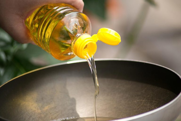 Pouring a food oil in hot pan for deep frying, 9 Types Of Oil That Don't Solidify In The Fridge