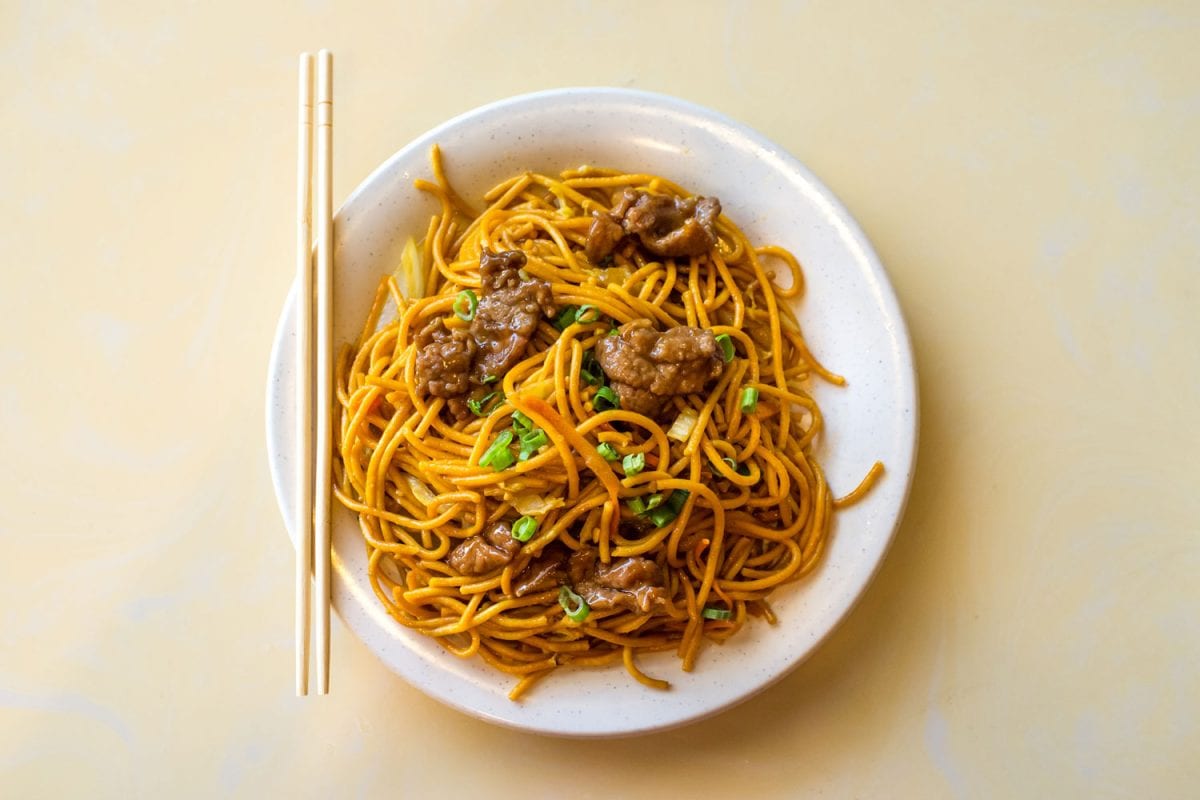 Stir fried noodles with chicken in a plate