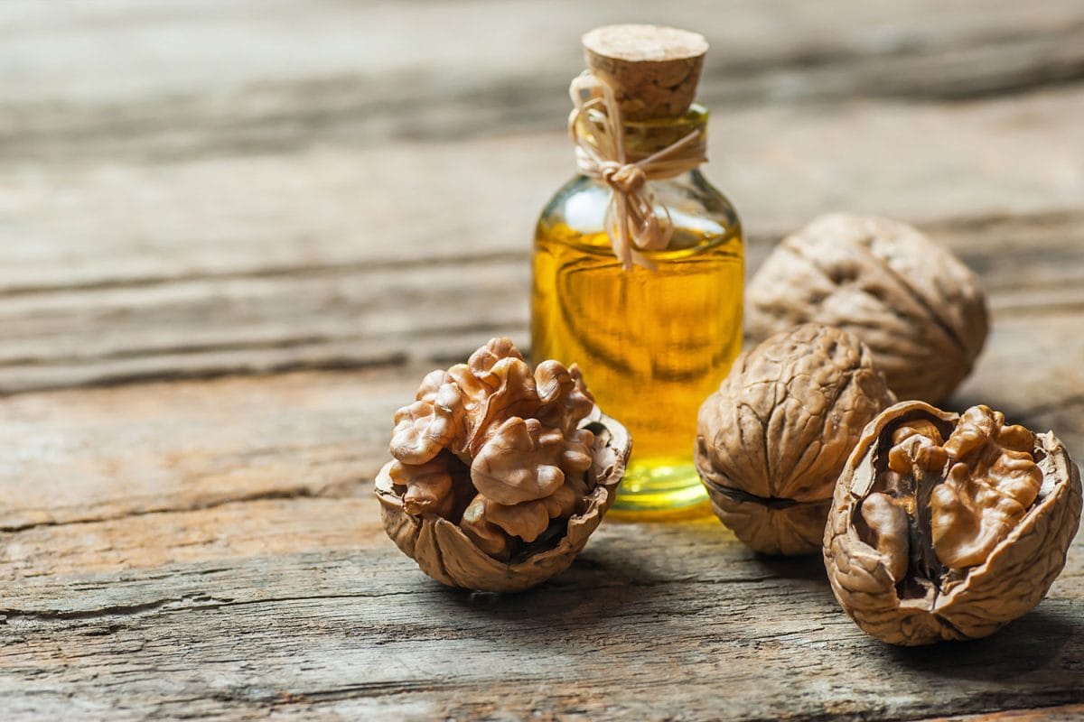 Walnuts and walnut oil extract on a table
