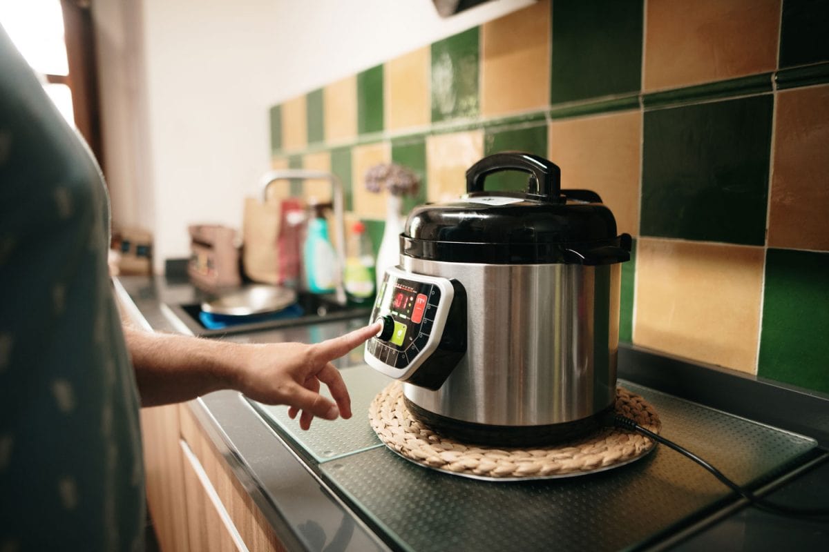 Woman setting the crockpot for her cooking in the kitchen