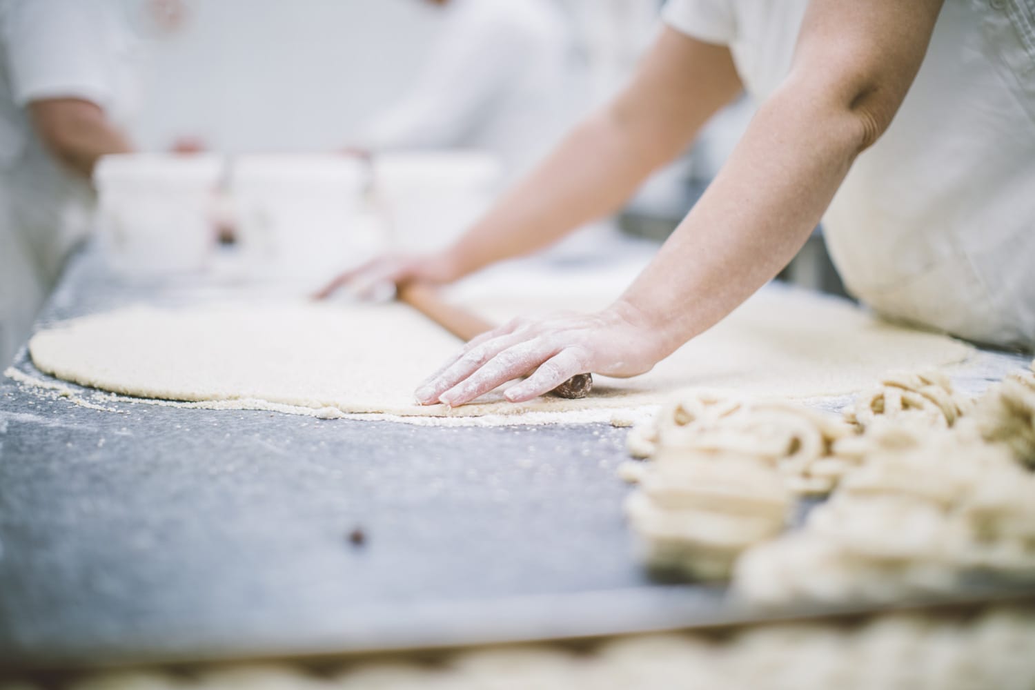 Women making puff pastry in professional kitchen