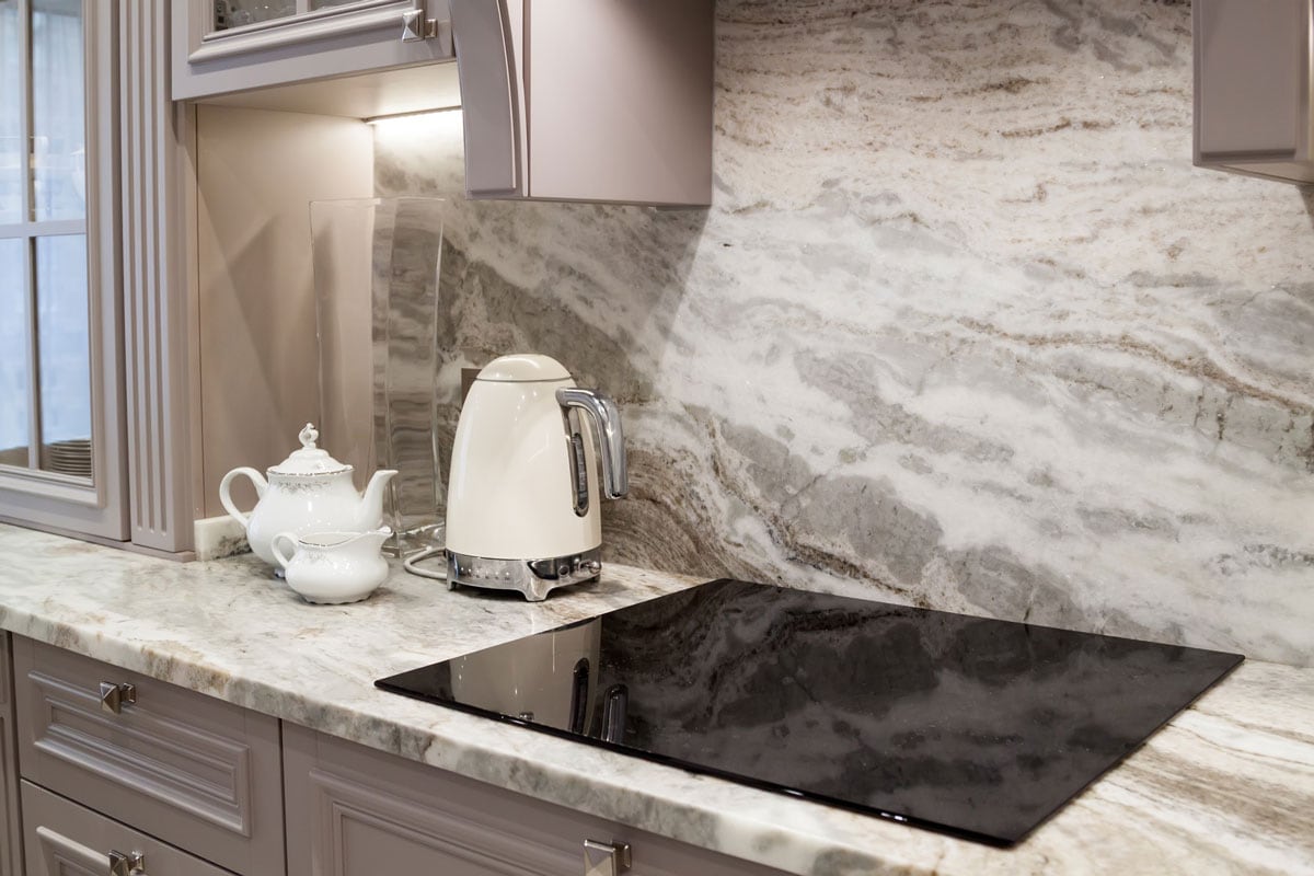 custom designed kitchen, with marble looking quartz countertop and backsplash