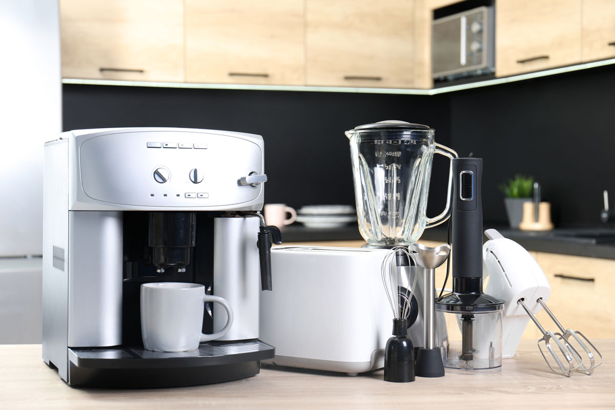 A big white coffee machine with a steamer and other kitchen appliances on the side
