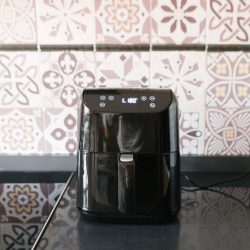A small black air fryer set to 180 degrees, Can You Put Wax/Parchment Paper In An Air Fryer? [And Should You?]