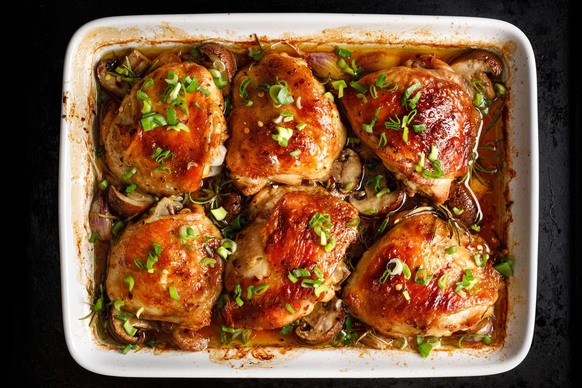 Baking chicken breasts garnished with chives