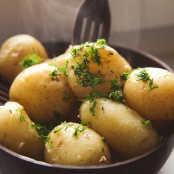 Boiled young potatoes with butter and dill served in the eco coconut bowl, How Long to Parboil Potatoes
