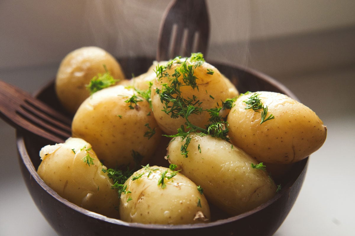 Boiled young potatoes with butter and dill served in the eco coconut bowl