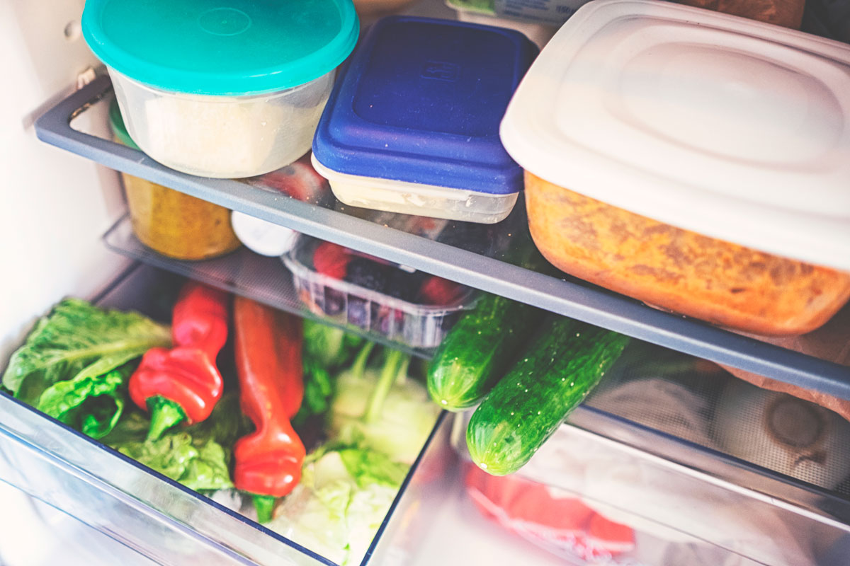 Food containers and other vegetables inside the fridge