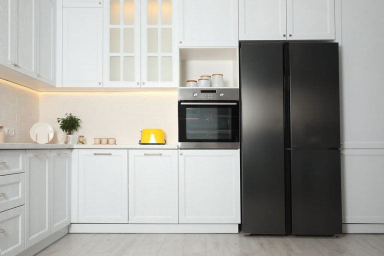 Gorgeous white cabinets and cupboards inside a bright kitchen, What Are The Standard Counter Depth Refrigerator Dimensions?